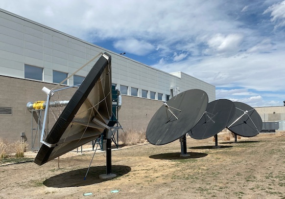 Four large satellite communication dishes installed outdoors near a light colored building at a MeteoStar facility Four large satellite communication dishes installed outdoors near a light colored building at a MeteoStar facility